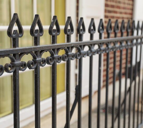black-iron-fence-with-yellow-door-that-says-no-longer-use_871349-6349