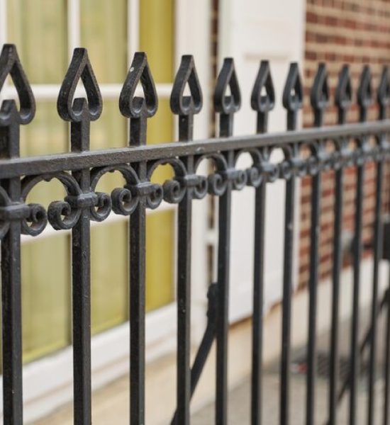 black-iron-fence-with-yellow-door-that-says-no-longer-use_871349-6349